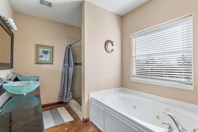 bathroom featuring a stall shower, visible vents, tile patterned floors, a whirlpool tub, and a sink