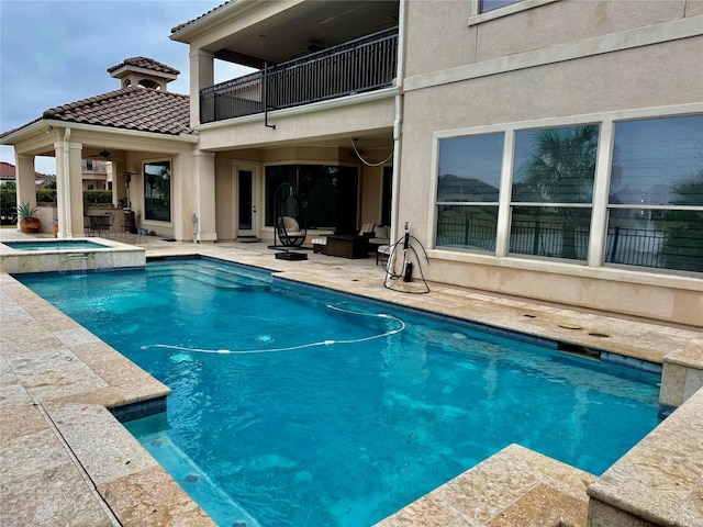 view of swimming pool featuring an in ground hot tub and a patio area