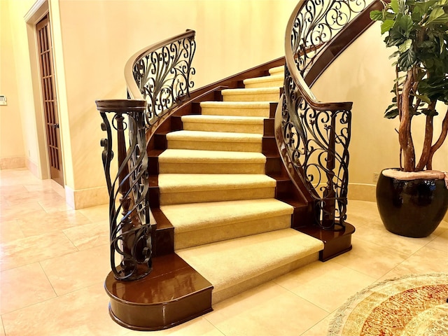 staircase with tile patterned floors