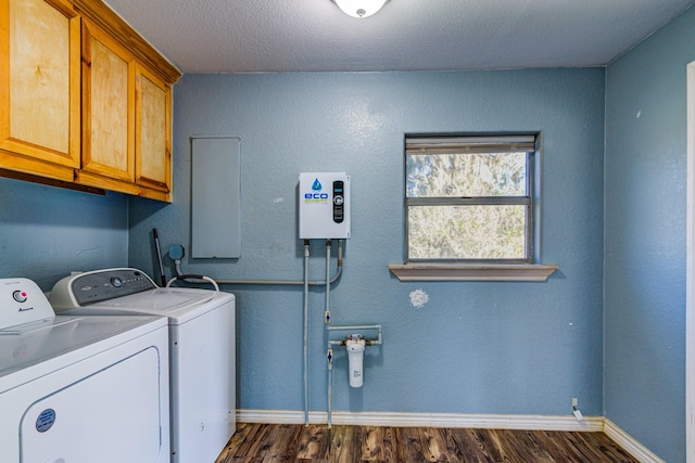 laundry room featuring washing machine and dryer, a textured ceiling, cabinets, and dark hardwood / wood-style floors