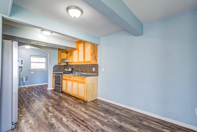 kitchen with appliances with stainless steel finishes, dark hardwood / wood-style flooring, decorative backsplash, light brown cabinets, and beam ceiling