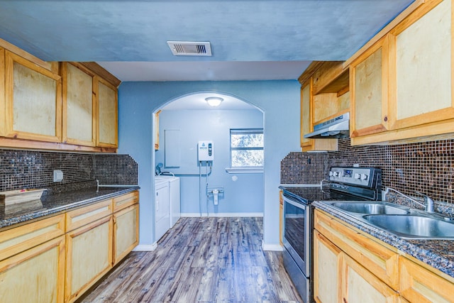 kitchen featuring stainless steel range with electric cooktop, sink, light brown cabinets, hardwood / wood-style floors, and separate washer and dryer