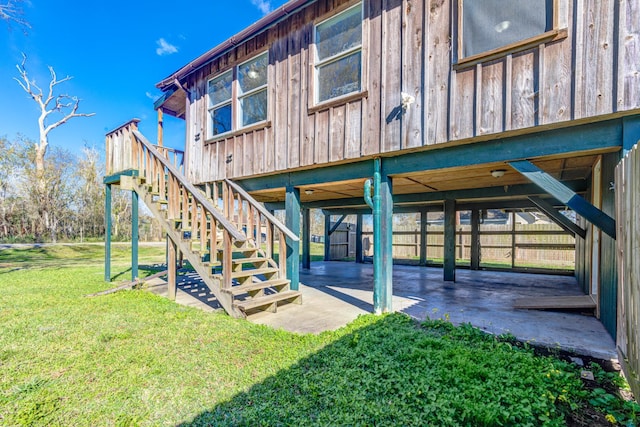 rear view of house featuring a patio area and a yard