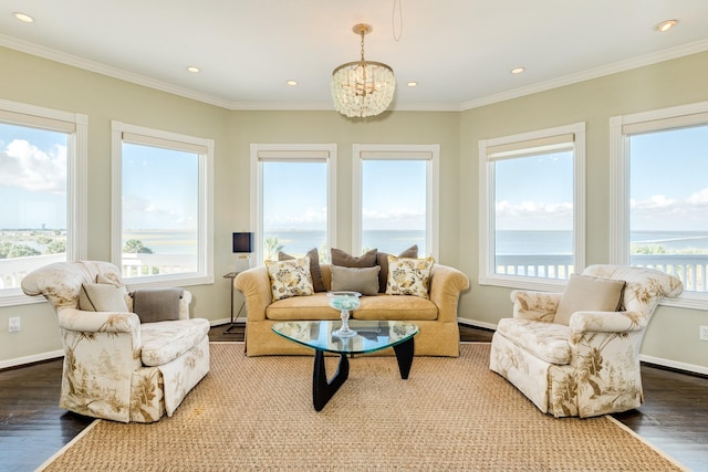 living room featuring a water view, crown molding, a chandelier, and hardwood / wood-style flooring