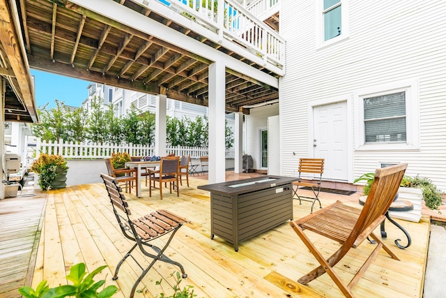 wooden terrace with an outdoor fire pit