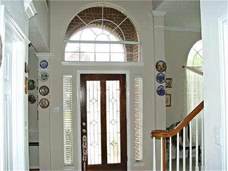 entrance foyer with ornamental molding and french doors