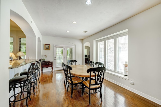 dining area with a textured ceiling and hardwood / wood-style flooring