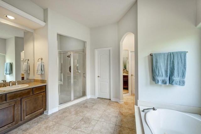 bathroom with vanity, tile patterned floors, and independent shower and bath