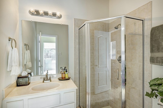 bathroom featuring an enclosed shower and vanity