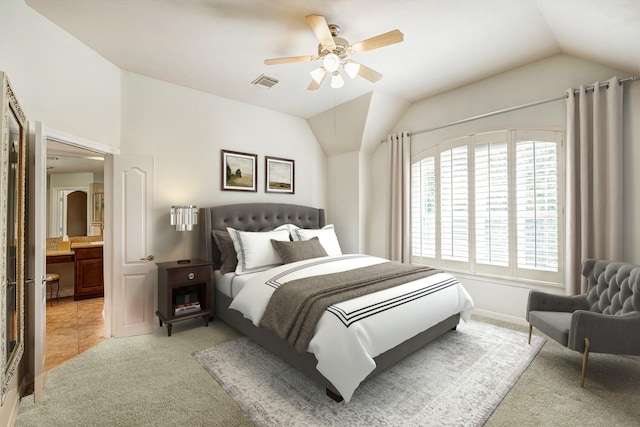 bedroom with ceiling fan, light colored carpet, ensuite bathroom, and lofted ceiling