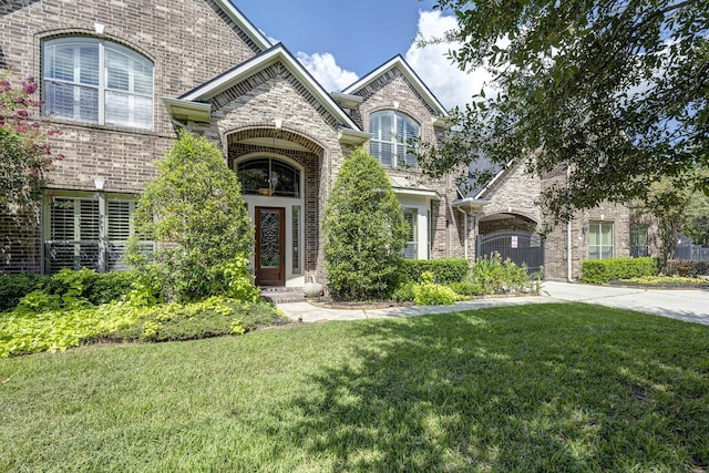 9051 Forest Cliff Ct, Conroe, TX 77302 - french country inspired facade with brick siding, a front yard, and driveway