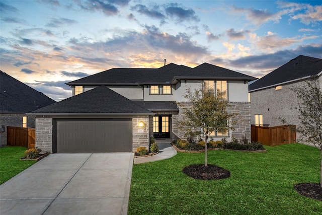 prairie-style house with a garage and a yard