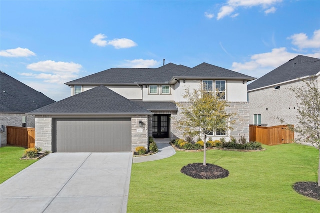 view of front of property featuring a garage and a front lawn