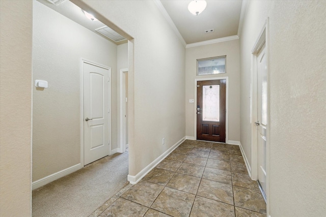 carpeted foyer with crown molding