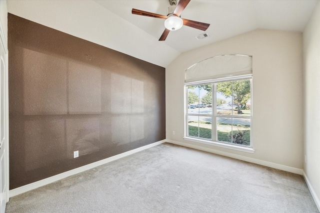 spare room with ceiling fan, carpet floors, and vaulted ceiling