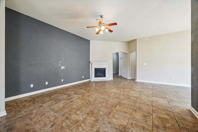 unfurnished living room with ceiling fan