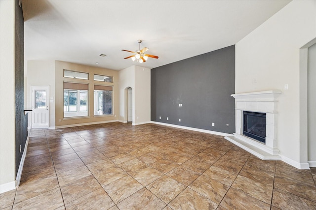 unfurnished living room with ceiling fan