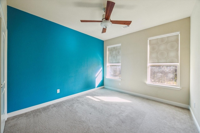 carpeted empty room featuring ceiling fan