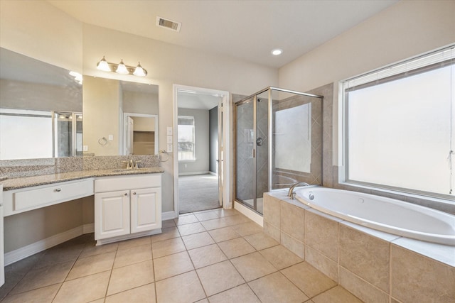 bathroom with tile patterned flooring, separate shower and tub, and vanity