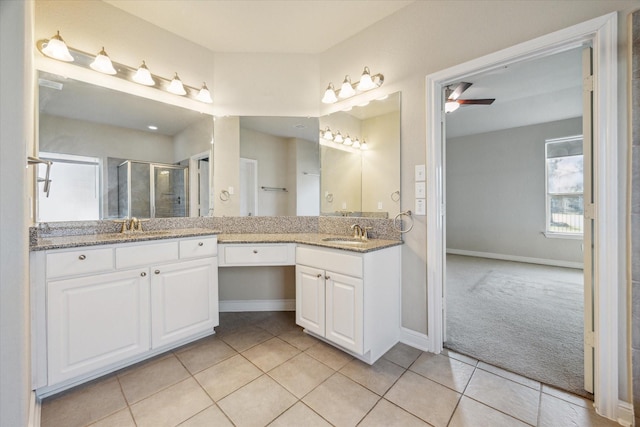 bathroom with tile patterned flooring, a shower with door, ceiling fan, and vanity