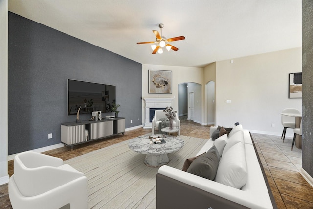 tiled living room featuring ceiling fan