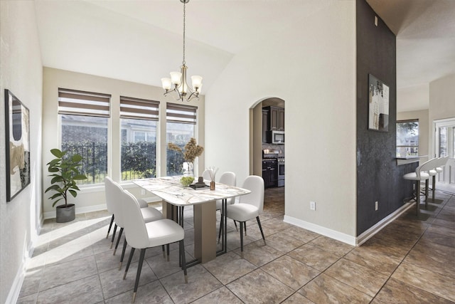 dining area featuring lofted ceiling and a chandelier