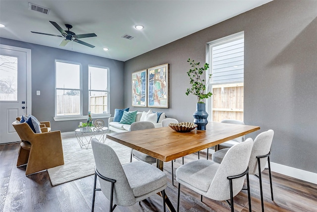 dining area with ceiling fan and dark hardwood / wood-style flooring