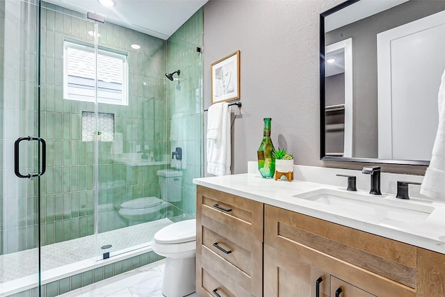 bathroom featuring walk in shower, vanity, and toilet