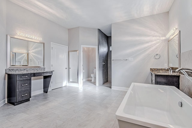 bathroom featuring toilet, a bathing tub, and vanity