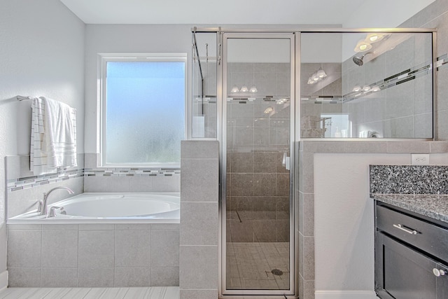 bathroom featuring plus walk in shower and vanity