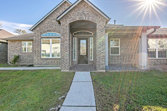 property entrance with a yard