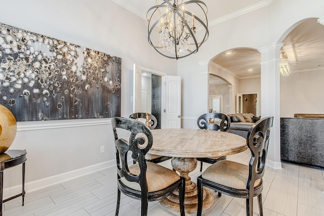 dining area featuring decorative columns, crown molding, and a chandelier