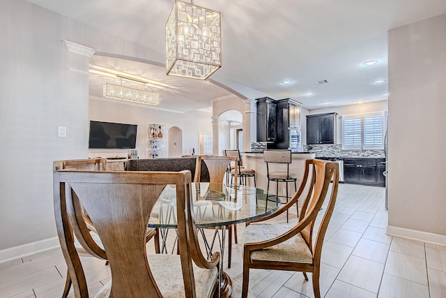 dining room featuring decorative columns