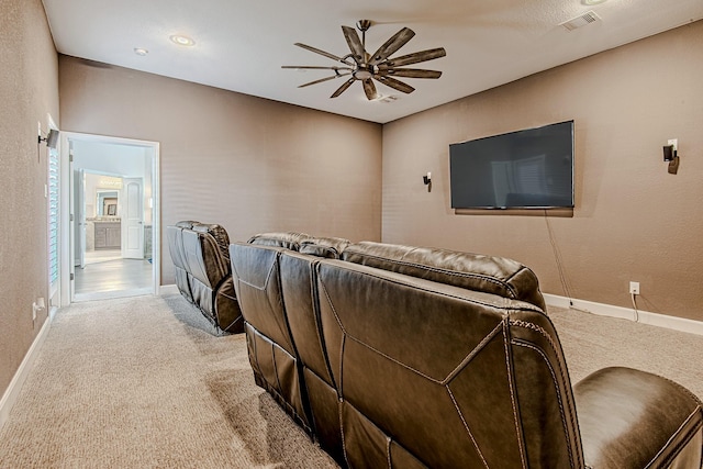 carpeted cinema room featuring ceiling fan