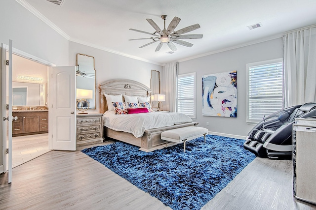 bedroom with ensuite bath, light hardwood / wood-style floors, crown molding, ceiling fan, and sink