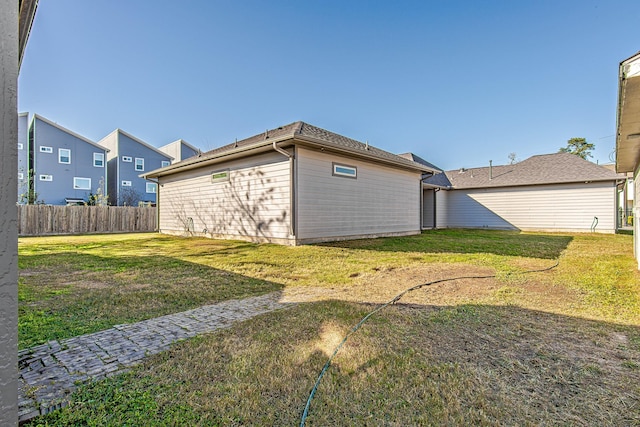 rear view of house with a lawn