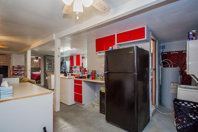 kitchen with black fridge, concrete floors, ceiling fan, and water heater