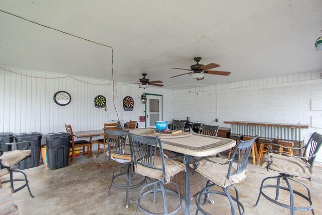 view of patio featuring a bar and ceiling fan