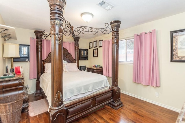 bedroom with hardwood / wood-style flooring