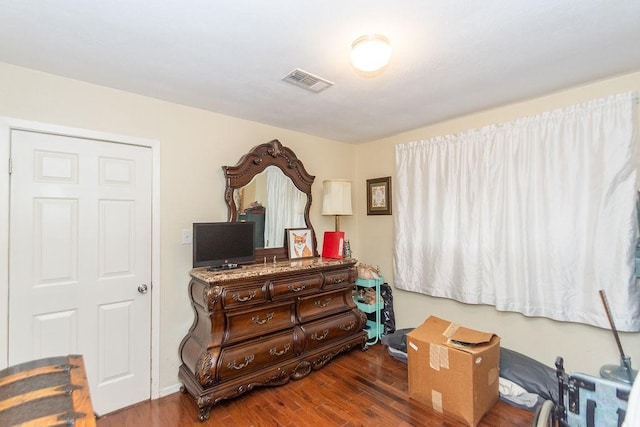 bedroom with dark hardwood / wood-style floors