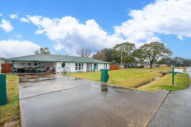 single story home featuring a front yard and a carport