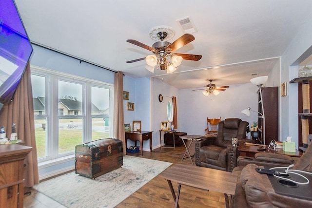 living room featuring ceiling fan and hardwood / wood-style flooring