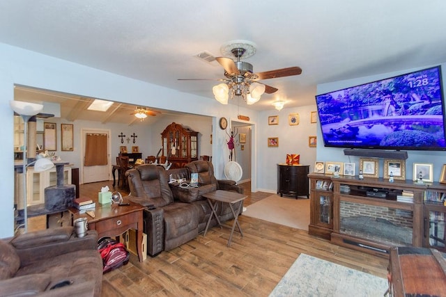 living room with ceiling fan and wood-type flooring