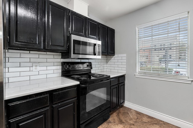 kitchen featuring dark tile patterned flooring, backsplash, and black range with electric cooktop