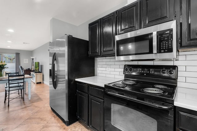 kitchen with stainless steel appliances, light tile patterned floors, and decorative backsplash