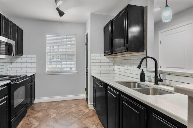 kitchen featuring sink, pendant lighting, backsplash, rail lighting, and black appliances