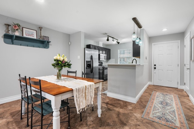 dining area featuring track lighting