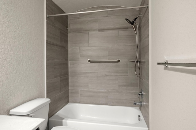 bathroom with toilet and tiled shower / bath combo