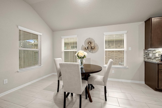 dining area with vaulted ceiling