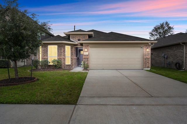 view of front of home with a lawn and a garage